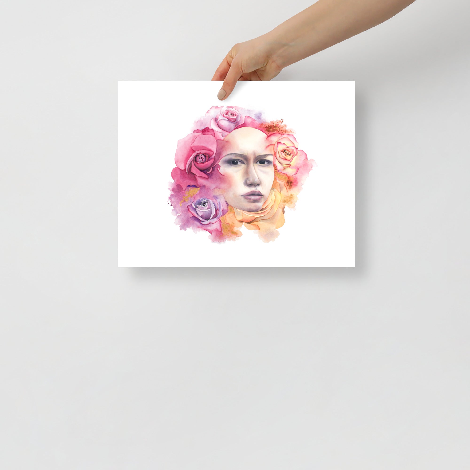 Hand holding an unframed giclée art print of A Quiet Moment by Paula Di Marco, featuring a surreal watercolor portrait surrounded by blooming roses, symbolizing feminine depth and serenity.