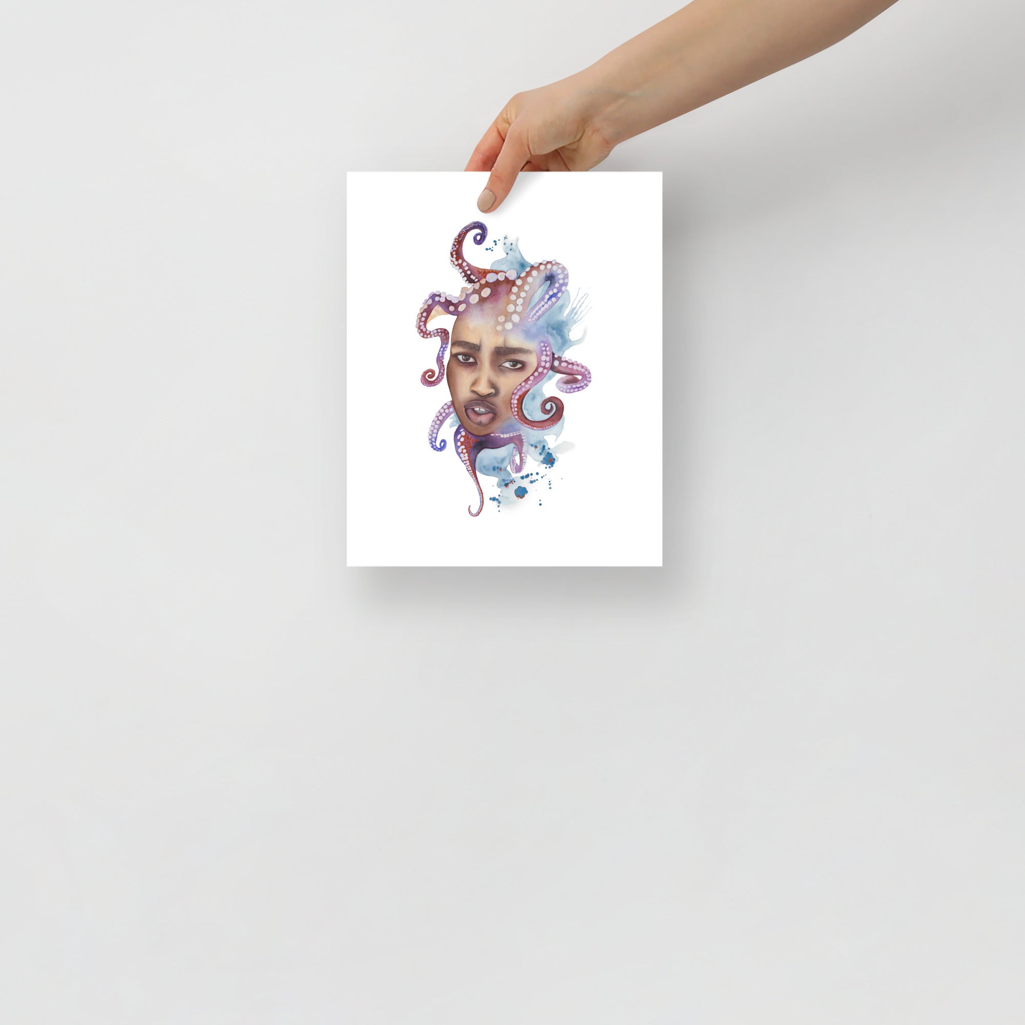 Hand presenting Paula Di Marco’s emotionally charged watercolor print Tangled, featuring octopus and portrait fusion. Size: 8x10 inch
