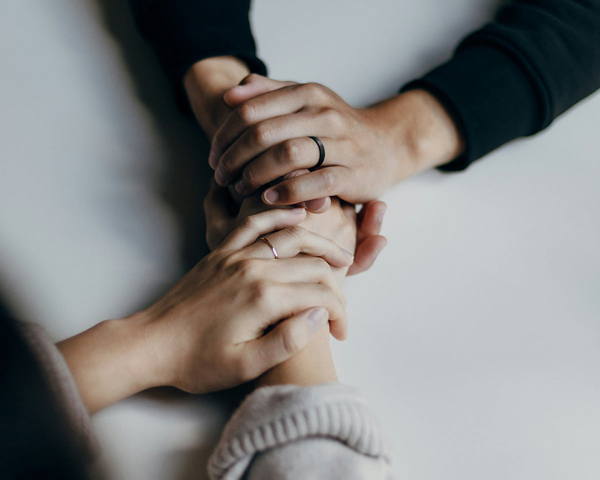 Friends holding hands across the table